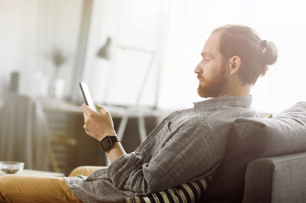 client watching a funeral live stream on his phone